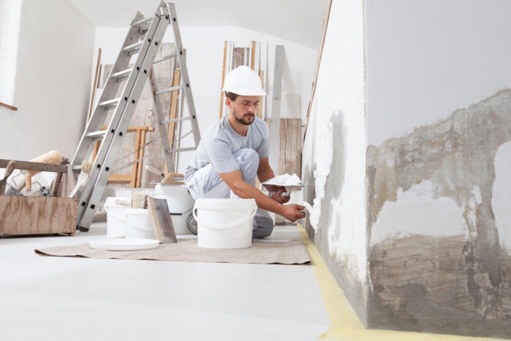 A painter doing interior painting services.