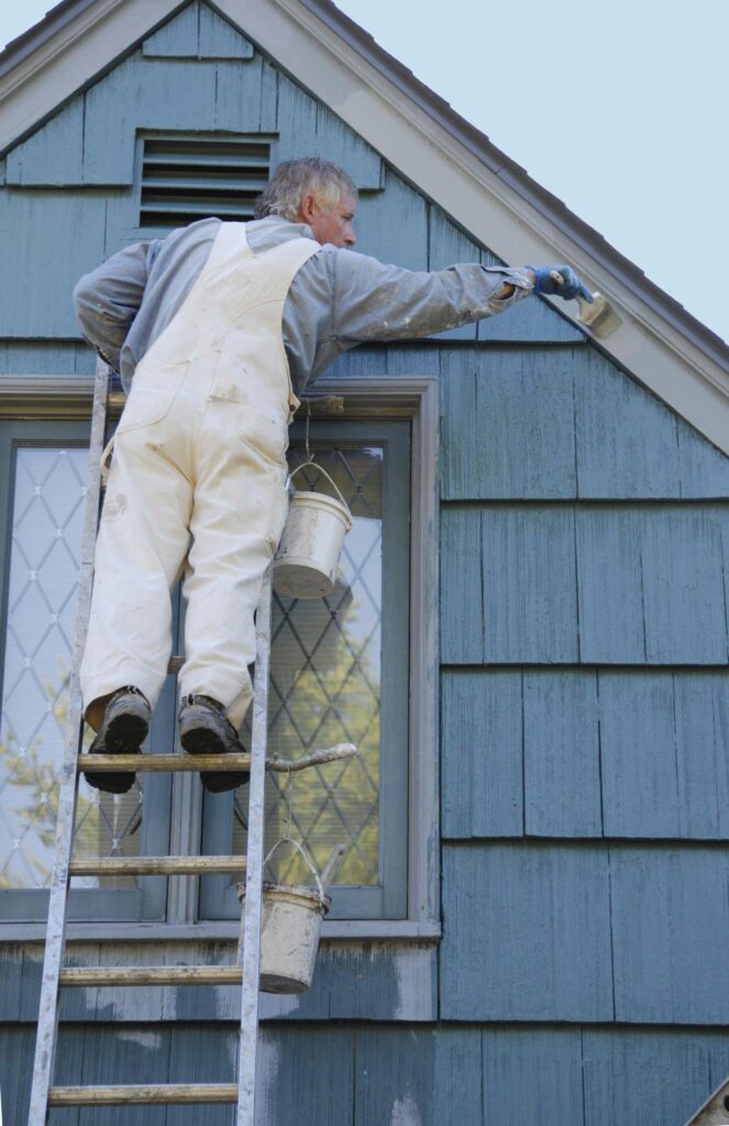 A painter doing exterior painting services.